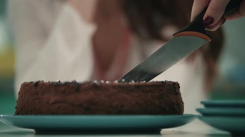 Female Hand Cutting Birtay Cake with Knife. Close Up of Woman Hand