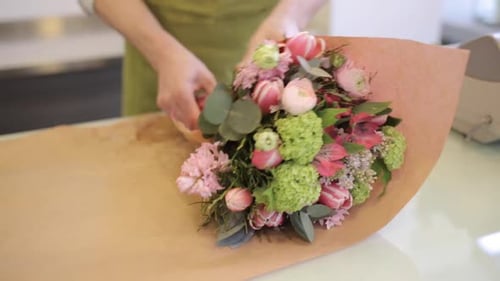 Florist Wrapping Bouquet at Flower Shop