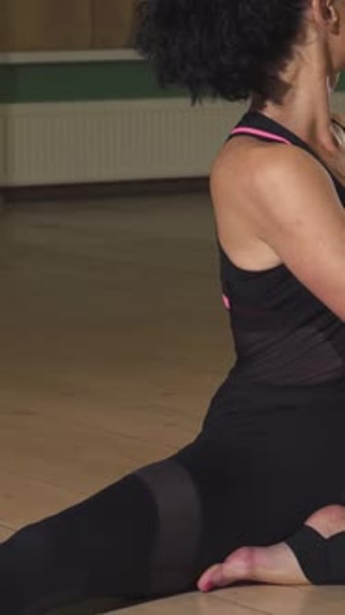 Woman Stretches Seated Doing Fitness Routine