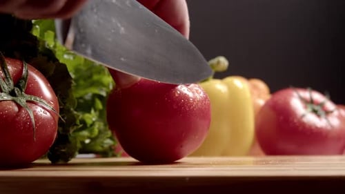 Slicing a Tomato on a Cutting Board