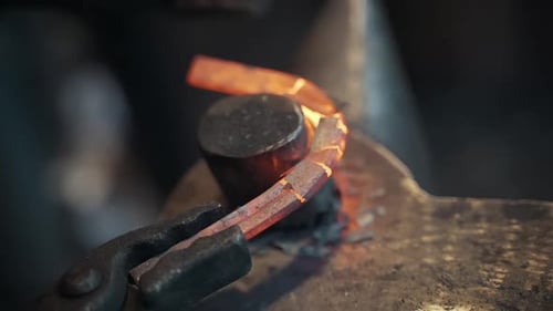 Craftsman Shaping Glowing Hot Metal on Anvil