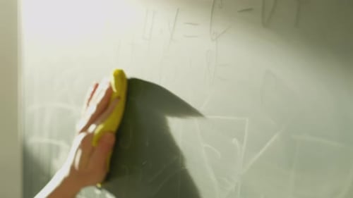 A Girl Student Writes on a Green Board