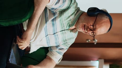 Adult Using a Laptop and Headphones at Home