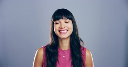 Smiling Woman Makes Heart Shape With Hands
