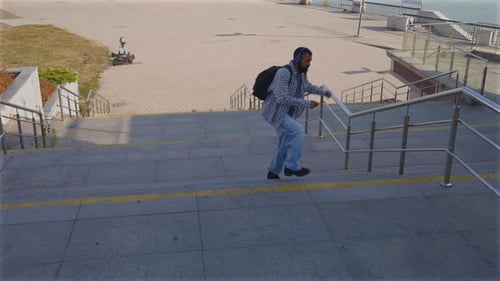 Man Walks Down Concrete Steps in Urban Area