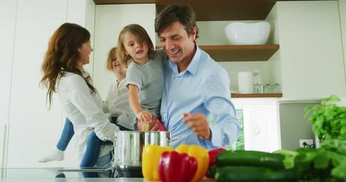 Authentic shot of lovely happy smiling parents and kids are enjoying their time and having fun to