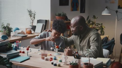 Father and Teen Paint Solar System Model