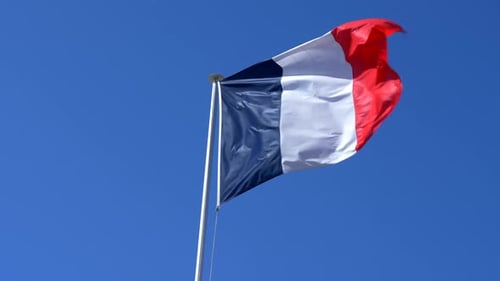 French Flag Waving against a Blue Sky
