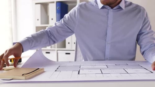Architecture, Building and Construction Concept - Male Architect with Living House Blueprint