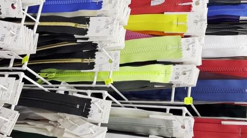 Many Different Zippers for Clothes of Different Sizes and Colors Zippers on Racks in the Workshop