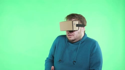 Man using VR Headset in Front of Green Screen