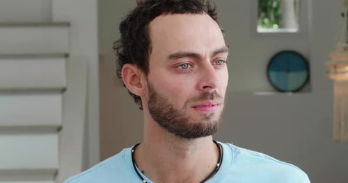 Closeup of a Handsome Peaceloving Young Caucasian Man Looking to the Side Looking at the Camera and