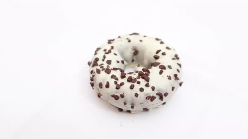 White Iced Donut with Chocolate Sprinkles Close Up