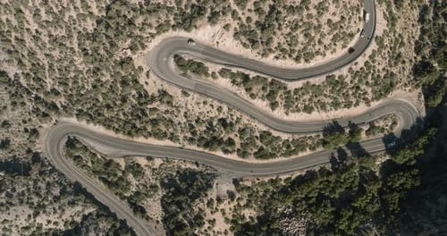 a winding road with cars on it