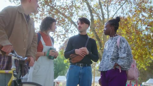 Group of Young Friends Chatting in the Park after Study