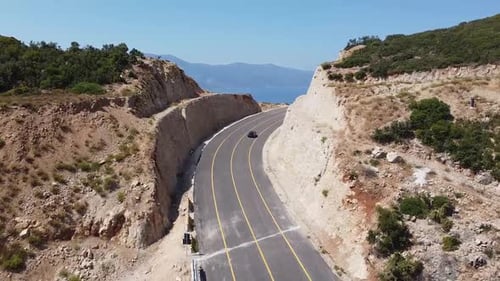 Aerial view of car driving on highway with sea view, Albania