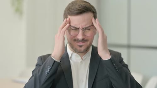 Adult Man With Headache Rubbing Temples