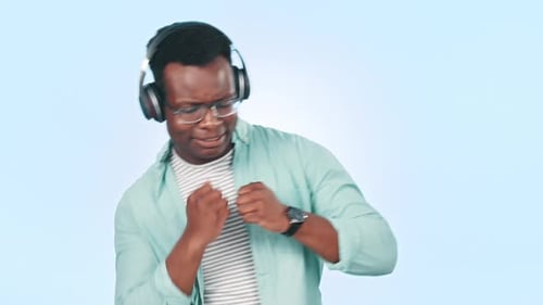 Music, dance and face of black man in studio for streaming song, radio and audio on blue background