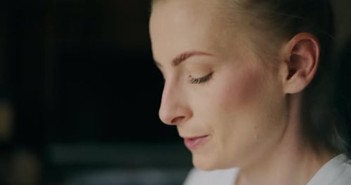 Woman drinking from a patterned mug in home