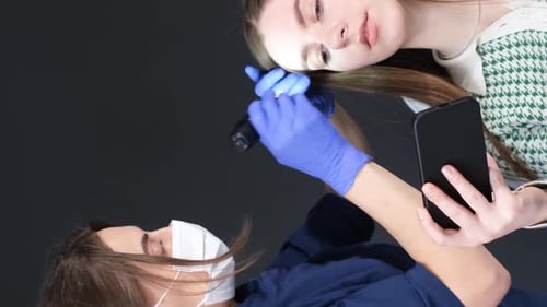 A Trichologist Examines the Patient's Hair with a Trichoscope in the Clinic Vertical Video