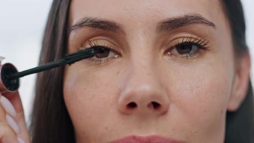Closeup Woman Colouring Eyelashes Indoor. Portrait Groomed Brown Eyed Model Preparing Daily Makeu...