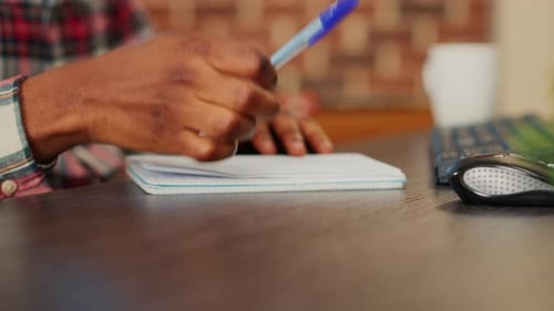 Young Adult Working at Home, Typing, Taking Notes