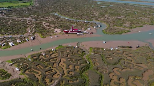 Flying high over Essex marina eroded marshland towards Tollesbury Lightship landmark