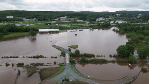 Flooded agricultural farm land after climate change disaster overflows river