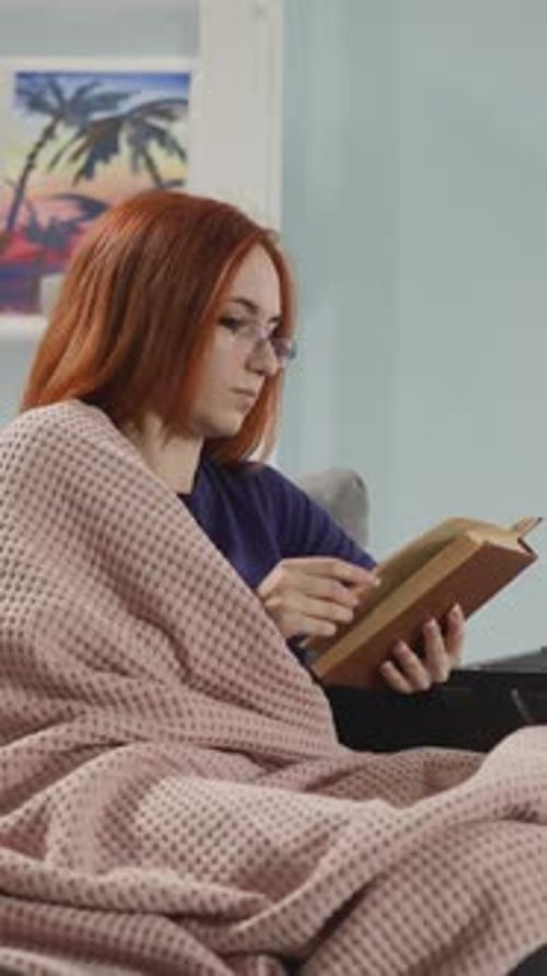 Woman Relaxing at Home Reading a Book
