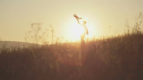 Child Playing with Toy Airplane at Sunset