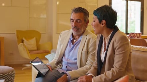 Business People Discussing Data on Tablet Indoors