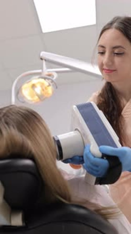 Dentist in Modern Clinic Performing Imaging Procedure on Patient Ensuring Comfort and Precision