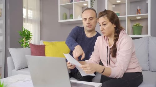 Adult Couple Working Together on Laptop at Home