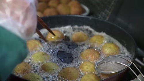 Falafel Balls Being Deep Fried in Hot Oil
