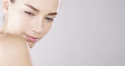 4k video footage of an alluring beautiful woman posing against a studio background