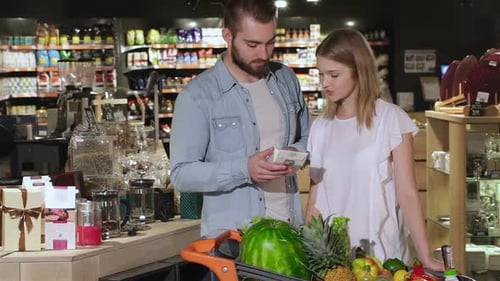 Couple Choose Tea at the Hypermarket