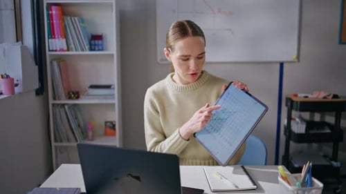 Woman Explaining Graph on Tablet During Online Lesson
