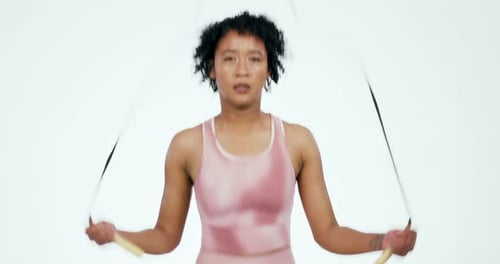 Athletic Woman Jump Roping in Pink Sportswear