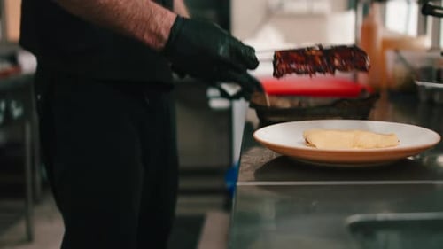 Chef Plates Glazed Ribs in Restaurant Kitchen