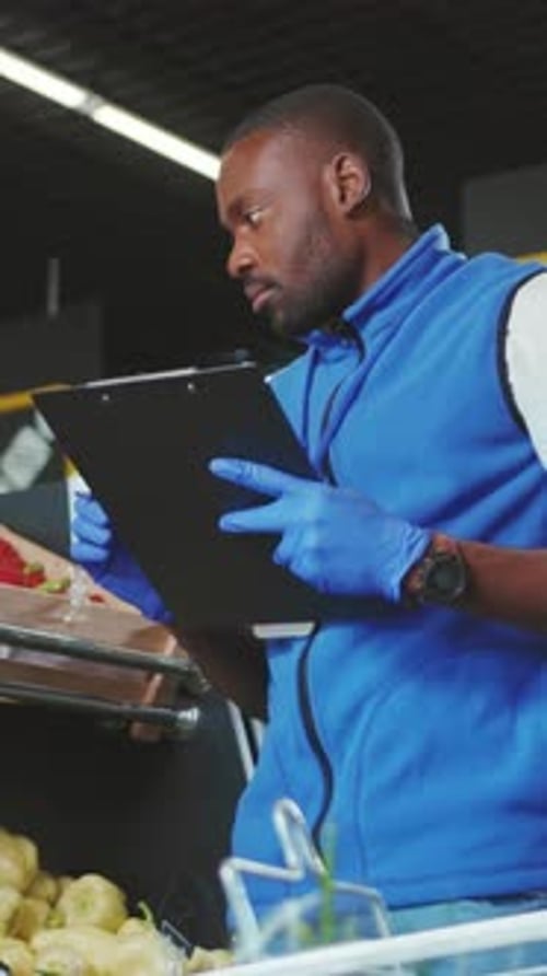 Professional Stocker Engaged in the Skillful Organization of Fresh Produce at a Market