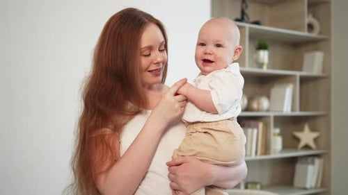 Loving Mother Holding her Adorable Baby Boy