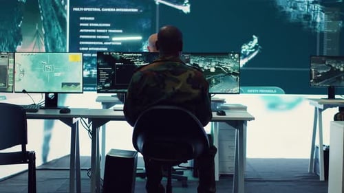 People Working in Front of Large Computer Monitors
