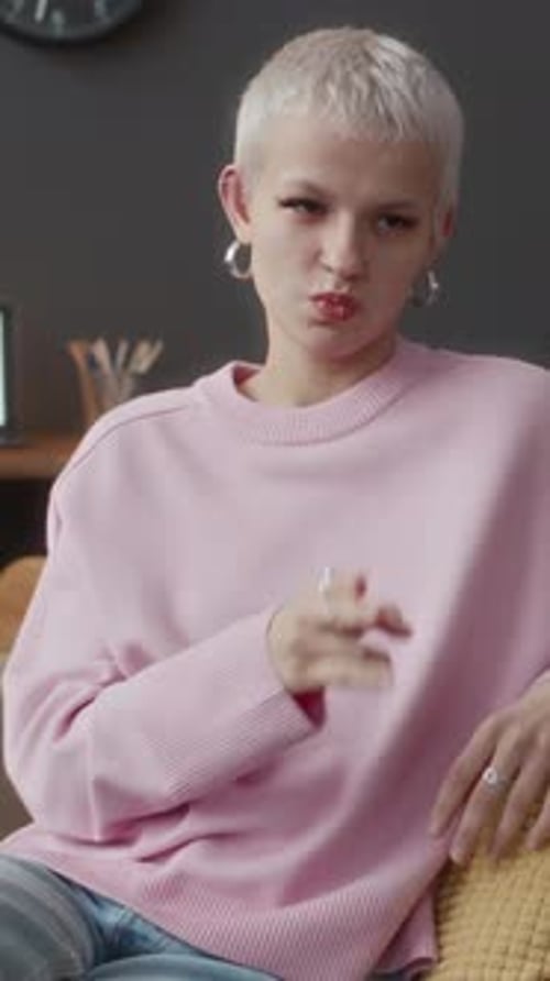 Woman Gesturing While Speaking on Couch