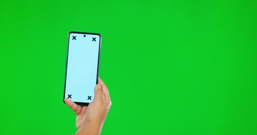 Person, hands and phone mockup on green screen for social media advertising against a studio