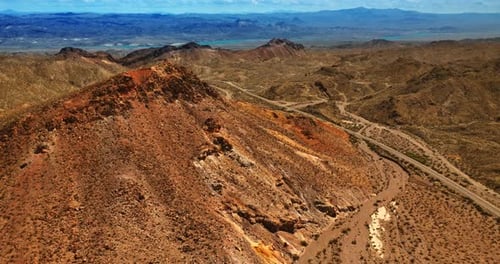Rocky dry mountainous landscape in Mojave desert. Brown sandy rocks from aerial perspective.
