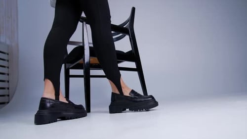 Legs with Loafers Posing Near a Chair