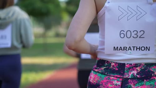 Back View Fit Sportswoman Running Marathon in Slow Motion with Friends