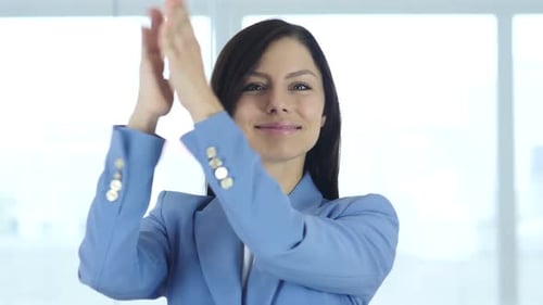 Woman in Blue Jacket Clapping Hands