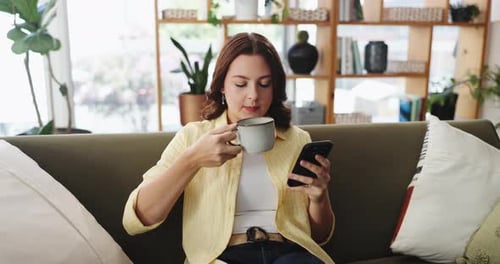 Coffee, phone and relax with woman on sofa in living room of home for social media post or update