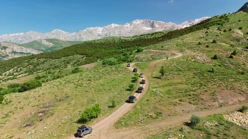 Aerial View of SUVs Driving on Mountain Trail in Scenic Summer Landscape